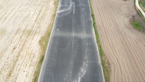 Aerial-overhead-drone-clip-of-the-empty-Wooodford-Aerodrome-airfield-airway-in-United-Kingdom