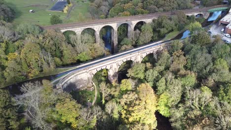 Backwards-reveal-into-clockwise-orbit-aerial-drone-clip-of-Marple-Aqueduct-and-Viaduct-in-the-United-Kingdom