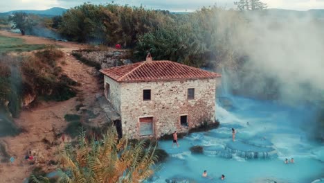 Tourists-At-The-Famous-Cascate-del-Mulino-In-Saturnia,-Manciano-In-Italy