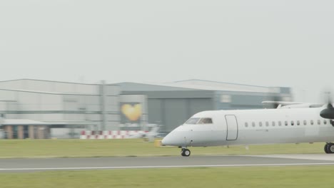 A-twin-propeller-plane-takes-off-from-a-runway