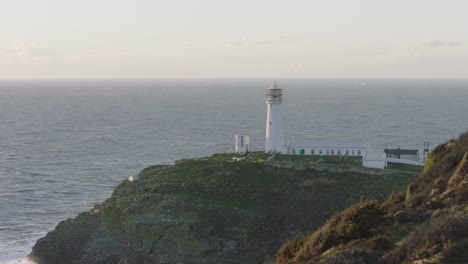 A-white-lighthouse-on-a-rocky-outcrop