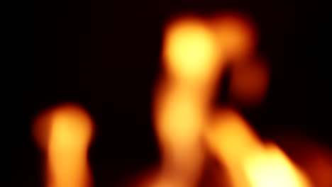 Bokeh-Flame-From-Burning-Woods-Of-A-Fireplace-Isolated-On-Black-Background