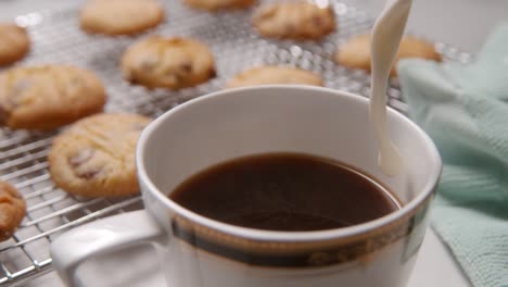 Milk-poured-into-nice-coffee-cup-with-cookies-2000-fps-Phantom