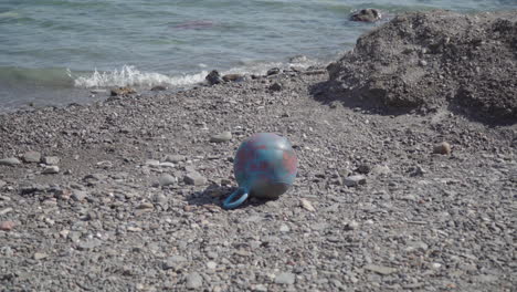 Buoy-marine-garbage-washed-ashore-on-beach,-human-impact,-litter-pollution