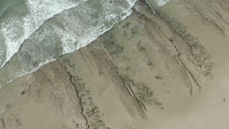 Drone-Shot-of-Waves-Hitting-a-Beach