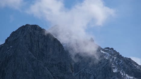 Close-up-view-of-cloud-rolling-trough-two-high-mountain-peaks