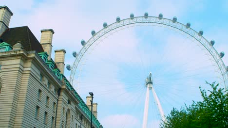 Cinematic-smooth-pan-of-The-London-Eye-against-blue-skies,-clouds-and-County-Hall-hotel-building,-shot-on-RED-Scarlet-W-5K
