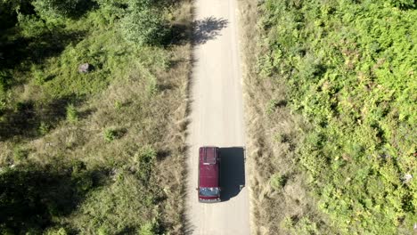 VW-Van-vintage-van-driving-through-forest-aerial-view-4k-drone