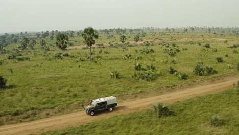 Offroad-vehicle-driving-through-African-savannah-at-speed-with-vast-plains