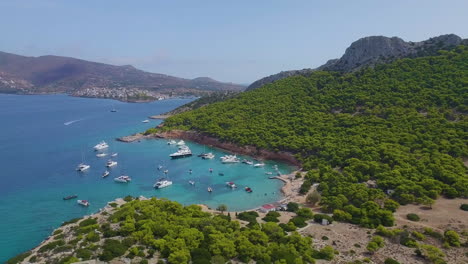 Ascending-drone-shot-of-moored-yachts-and-catamarans-on-a-beautiful-bay-for-diving