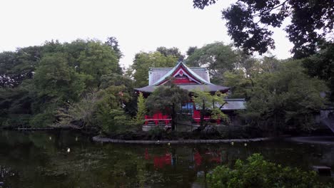In-Kichijoji-Park,-in-Tokyo,-there-is-a-beautiful-red-Shinto-temple