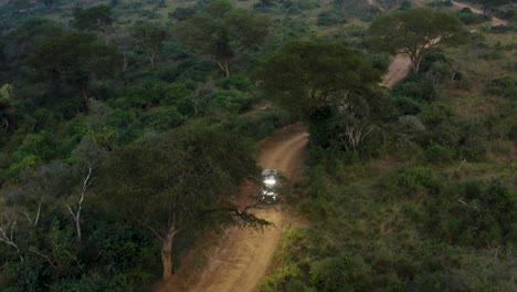 Off-road-ambulance-drives-down-dirt-road-in-Africa-searching-for-poachers