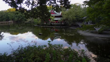 Im-Kichijoji-Park-In-Tokio-Gibt-Es-Einen-Wunderschönen-Sinto-tempel,-Der-Von-Intensiver-Natur-Und-Einem-Großen-See-Umgeben-Ist,-Der-Seine-Gestalt-Widerspiegelt