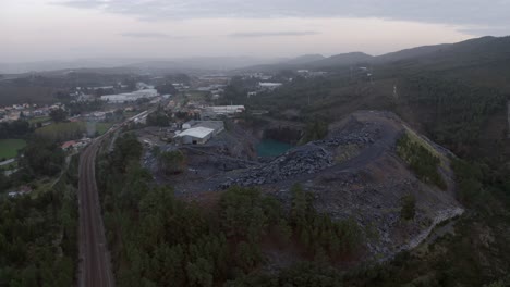 Drone-view-of-a-railway-with-trains-on-it-near-a-quarry-in-Portugal