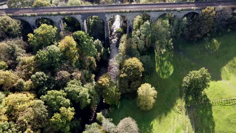 Revealing-aerial-drone-clip-of-River-Goyt-passing-underneath-the-Marple-Aqueduct-and-Viaduct-in-the-United-Kingdom-with-brief-purple-flaring