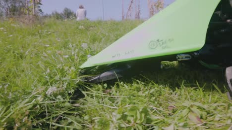 Man-Cutting-Green-Grass-In-The-Farm-With-A-Paddock-Mower---close-up
