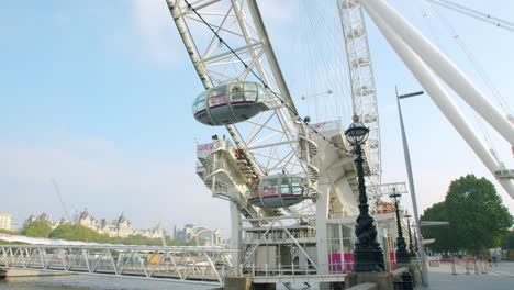 Cinematic-slow-motion-gimbal-walk-of-The-London-Eye-Capsules-over-the-Thames-River-on-a-sunny-day