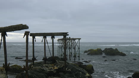 Ruins-of-the-historic,-120-year-old-pier-in-Llico,-Vichuquen,-Chile,-wide-shot