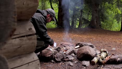 Backpacker-Pouring-Campfire-Coffee-in-a-Cup-in-a-Forest-Camp