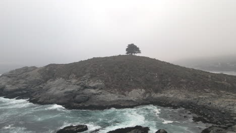 AERIAL---Foggy-Cerro-de-la-Cruz,-Zapallar,-Valparaiso,-Chile,-wide-forward-shot
