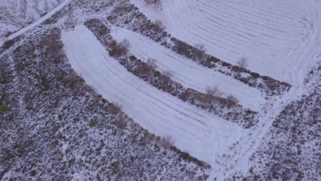 Drone-footage-of-birdseye-view-of-snowy-mountains-and-fields-in-spain