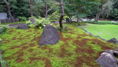 Garden-design-is-a-fundamental-art-in-all-temples-in-Japan,-where-large-stones-and-different-types-of-mosses-are-perfectly-combined