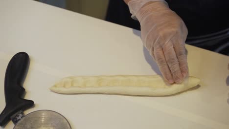 Baker-Pressing-Middle-Portion-Of-The-Dough-And-Put-Chocolate-Chips-On---high-angle,-slow-motion