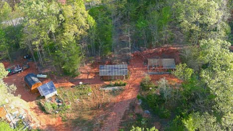 drone-flight-over-a-small-off-grid-lot-with-green-house