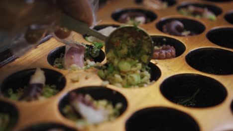 Putting-A-Scoop-Of-Mixed-Vegetables-Into-Takoyaki-Pan