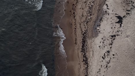 Aerial-view-of-drones-flying-over-waves-on-the-sand-beach-view-from-above