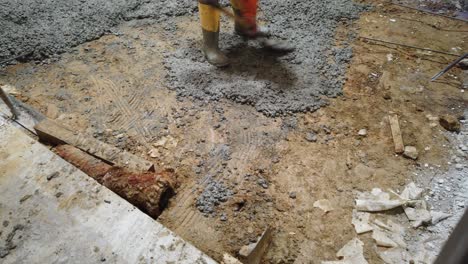 man-working-of-poring-new-cement-floor