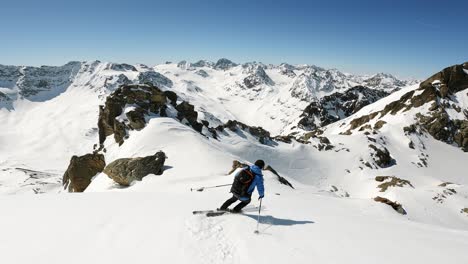 Backcountry-ski-tour-in-high-alpine-mountain-terrain-with-a-ski-guide