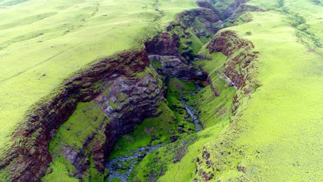 Flying-over-lush-green-canyon-on-east-side-of-Maui,-Hawaii