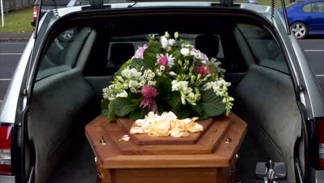 closeup-shot-of-a-funeral-casket-or-coffin-in-a-hearse-or-chapel-or-burial-at-cemetery