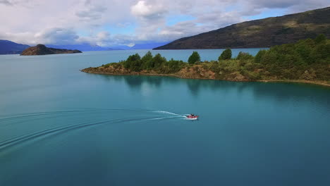 AERIAL---A-fast-boat-in-General-Carrera-Lake,-Patagonia,-Chile,-wide-shot