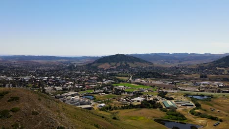 Aerial-panning-shot-of-San-Luis-Obispo-and-beautiful-surrounding-landscape
