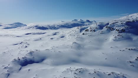 Beautiful-slow-aerial-shot-over-snowy-winter-landscape-in-the-arctic-mountains