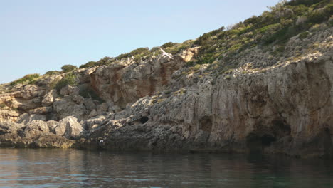 Cliffs-on-a-sunny-day-with-blue-sky-on-the-Mediterranean-coast-of-Ibiza,-Spain