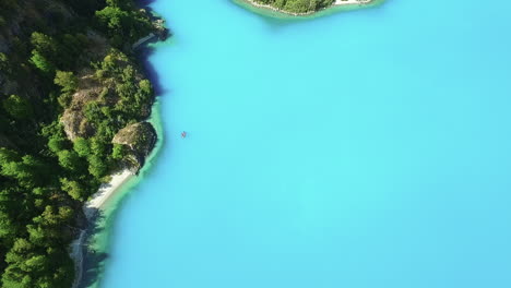 AERIAL---Turquoise-waters-of-General-Carrera-Lake,-Chile,-wide-shot-top-down