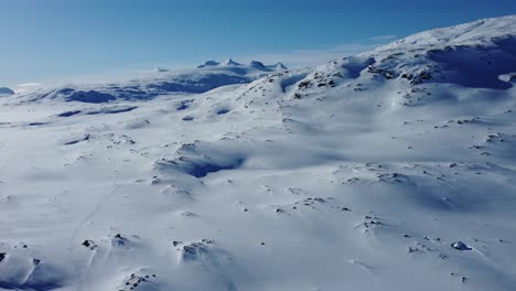 Beautiful-aerial-shot-of-a-winter-landscape-with-snow-covered-mountains-in-Sweden