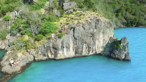 AERIAL---Jumping-into-the-turquoise-waters-of-General-Carrera-Lake,-Chile