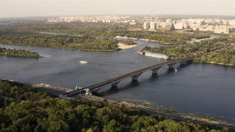 AERIAL---The-Patona-Bridge-on-the-Dnieper-River,-Kiev,-Ukraine,-wide-shot-forward