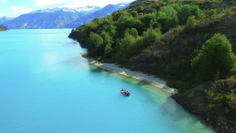 AERIAL---Tour-boat-in-General-Carrera-Lake,-Patagonia,-Chile,-wide-shot-rising