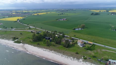 Panoramic-View-Of-Swedish-Countryside-With-Road-And-Green-Fields-Near-The-Beach-At-Skane,-Sweden