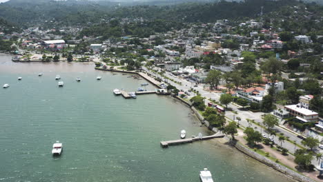 AERIAL---Port-and-docks-of-Samana,-Dominican-Republic,-forward-lowering-approach
