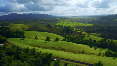 Verdant-Hilly-Landscape-With-A-Country-Road-Over-Atherton-Tablelands-In-Queensland,-Australia