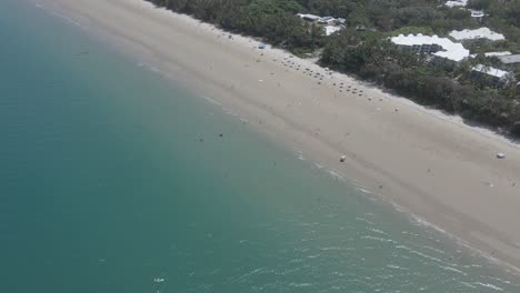 Tourists-Swim-At-Four-Mile-Beach-With-Calm-Blue-Ocean---Port-Douglas-In-Far-North-Queensland
