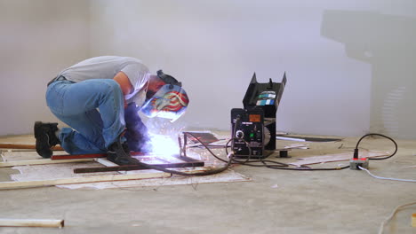 Professional-Blacksmith-Welding-Steel-Frame-With-Portable-Welding-Machine