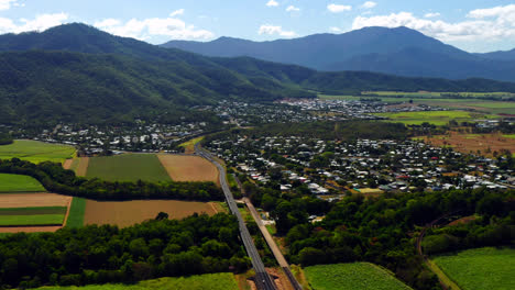 Panoramic-View-on-Suburban-Cairns-with-Green-Fields-and-Mountains-in-Queensland,-Australia---aerial-shot