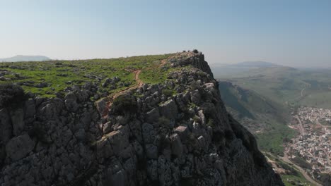 Aerial-view-around-the-rocky-Mount-Arbel-mountain,-in-sunny-Israel---circling,-drone-shot